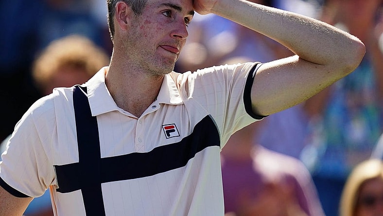Aug 31, 2023; Flushing, NY, USA;  John Isner of the United States reacts as he is interviewed after losing his second round match against Michael Mmoh of the United States on day four of the 2023 U.S. Open tennis tournament at the USTA Billie Jean King National Tennis Center. Mandatory Credit: Jerry Lai-USA TODAY Sports