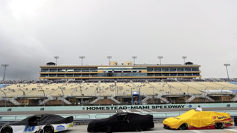 Jun 14, 2020; Homestead, Florida, USA; A general view as cars are covered during a rain delay prior to the NASCAR Cup series race at Homestead-Miami Speedway. Mandatory Credit: Wilfredo Lee/Pool Photo via USA TODAY Network