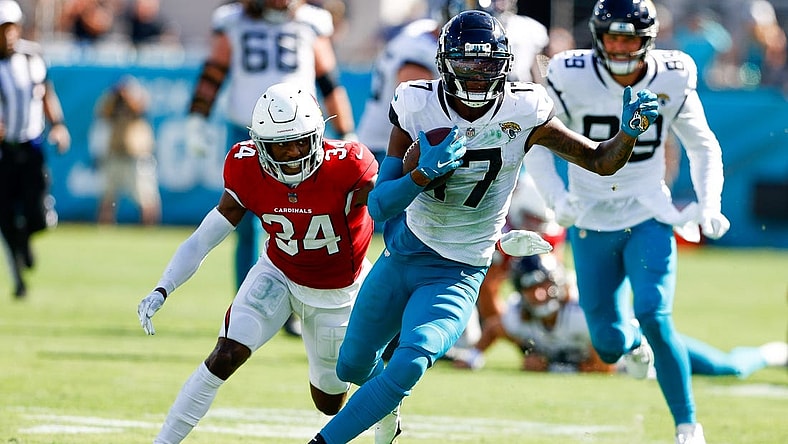 Sep 26, 2021; Jacksonville, Florida, USA; Jacksonville Jaguars wide receiver D.J. Chark (17) runs with the ball while being chased by Arizona Cardinals defensive back Jalen Thompson (34) in the fourth quarter at TIAA Bank Field. Mandatory Credit: Nathan Ray Seebeck-USA TODAY Sports