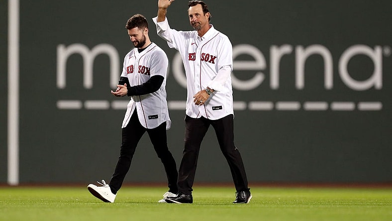 Oct 19, 2021; Boston, Massachusetts, USA; Former Boston Red Sox pitcher Tim Wakefield and singer-songwriter Calum Scott walk onto the field for a ceremonial first pitch before game four of the 2021 ALCS between the Boston Red Sox and the Houston Astros at Fenway Park. Mandatory Credit: Paul Rutherford-USA TODAY Sports