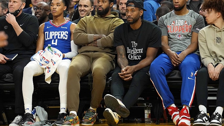 Mar 8, 2022; San Francisco, California, USA; LA Clippers guard Paul George (center, left) and forward Kawhi Leonard (center, right) sit in street clothes on the bench during the second quarter against the Golden State Warriors at Chase Center. Mandatory Credit: Darren Yamashita-USA TODAY Sports