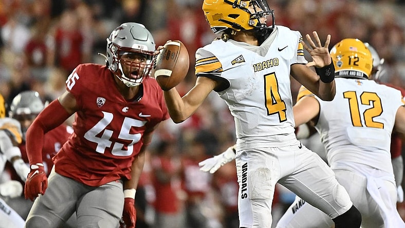 Sep 3, 2022; Pullman, Washington, USA; Idaho Vandals quarterback Gevani McCoy (4) throws the ball against Washington State Cougars defensive end Raam Stevenson (45) in the second half at Gesa Field at Martin Stadium. Mandatory Credit: James Snook-USA TODAY Sports