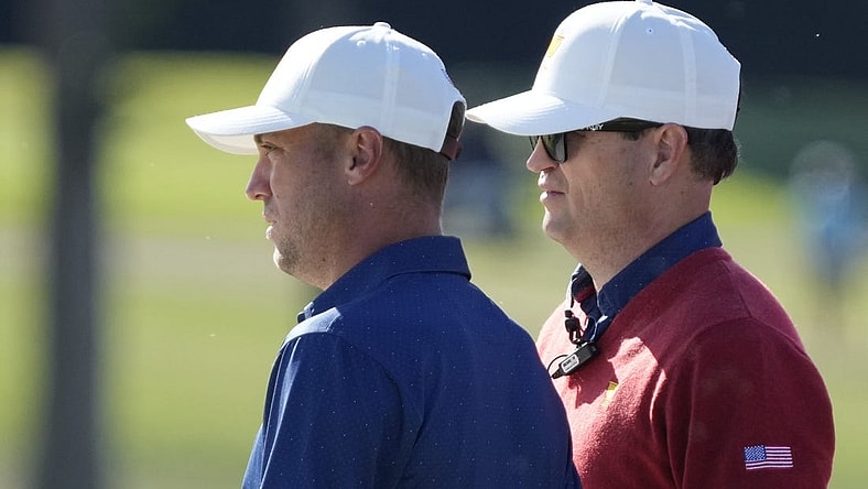 Team USA golfer Justin Thomas (left) and assistant captain Zach Johnson (right) talk on the 13th green during the foursomes match play of the Presidents Cup golf tournament at Quail Hollow Club (file photo). Mandatory Credit: Jim Dedmon-USA TODAY Sports