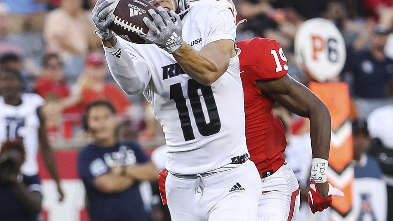 Sep 24, 2022; Houston, Texas, USA; Rice Owls wide receiver Luke McCaffrey (10) makes a reception and runs for a touchdown as Houston Cougars defensive back Alex Hogan (19) defends during the third quarter at TDECU Stadium. Mandatory Credit: Troy Taormina-USA TODAY Sports