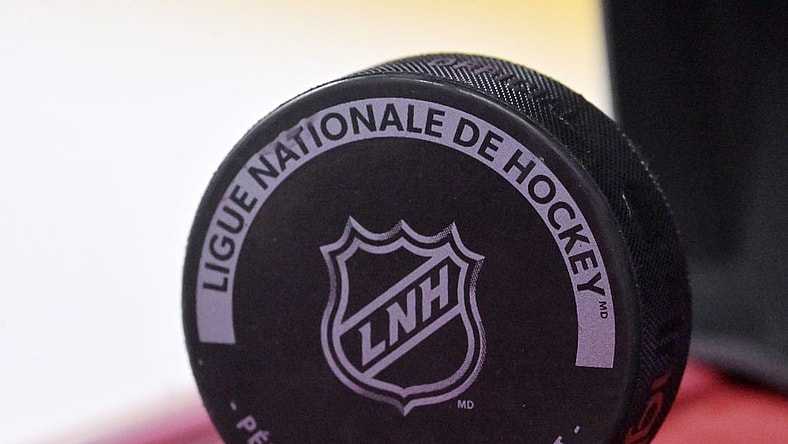 Oct 4, 2022; Montreal, Quebec, CAN; A puck with the NHL logo during the warmup period before the game between the Ottawa Senators and the Montreal Canadiens at the Bell Centre. Mandatory Credit: Eric Bolte-USA TODAY Sports