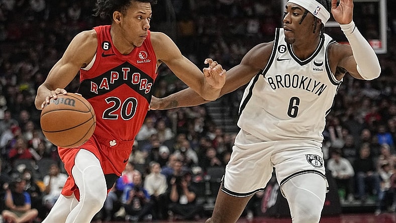 Nov 23, 2022; Toronto, Ontario, CAN; Toronto Raptors guard Jeff Dowtin (20) drives to the net against Brooklyn Nets forward David Duke Jr. (6) during the second half at Scotiabank Arena. Mandatory Credit: John E. Sokolowski-USA TODAY Sports