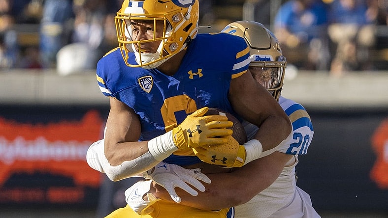 November 25, 2022; Berkeley, California, USA; California Golden Bears running back Jaydn Ott (6) is tackled by UCLA Bruins linebacker Kain Medrano (20) during the second quarter at California Memorial Stadium. Mandatory Credit: Kyle Terada-USA TODAY Sports