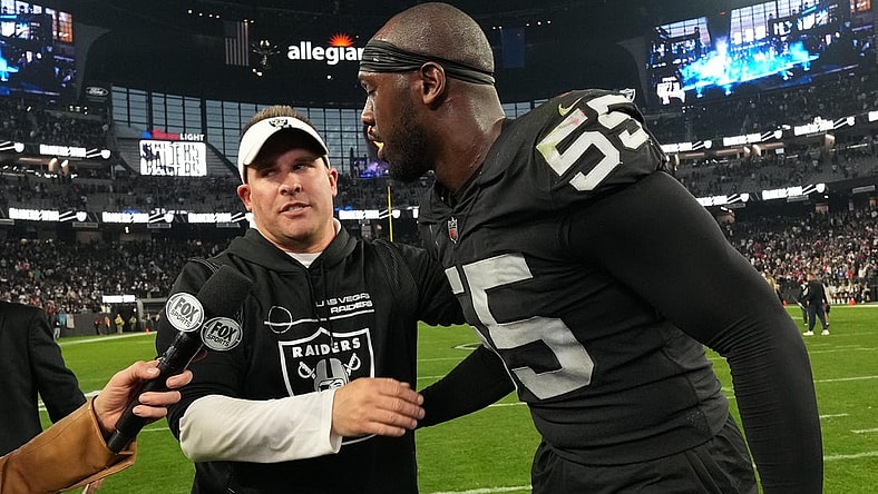 Dec 18, 2022; Paradise, Nevada, USA; Las Vegas Raiders coach Josh McDaniels (left) and defensive end Chandler Jones (55) embrace at the end of the game against the New England Patriots at Allegiant Stadium. The Raiders defeated the Patriots 30-24. Mandatory Credit: Kirby Lee-USA TODAY Sports
