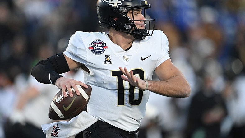 Dec 28, 2022; Annapolis, Maryland, USA; UCF quarterback John Rhys Plumlee (10) throws own the run against Duke in the 2022 Military Bowl at Navy-Marine Corps Memorial Stadium. Mandatory Credit: Tommy Gilligan-USA TODAY Sports