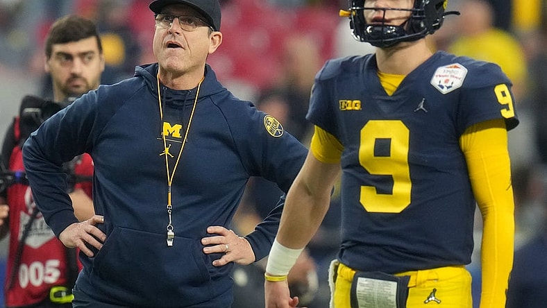 Dec 31, 2022; Glendale, Arizona, USA; Michigan Wolverines head coach Jim Harbaugh watches as J.J. McCarthy (9) warms up before they take on the TCU Horned Frogs in the Vrbo Fiesta Bowl at State Farm Stadium. Mandatory Credit: Joe Rondone-Arizona Republic

Ncaa Fiesta Bowl Game