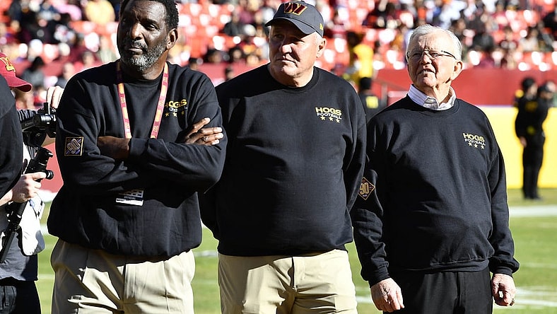 Jan 1, 2023; Landover, Maryland, USA; Washington Commanders former head coach Joe Gibbs and former quarterbacks Doug Williams (left) and Mark Rypien (center) on the field before the game at FedExField. Mandatory Credit: Brad Mills-USA TODAY Sports
