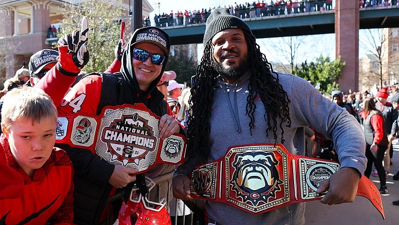 Jan 14, 2023; Athens, GA, USA; Georgia Bulldogs fan and assistant coach Jarvis Jones hold belts at the national championship celebration at Sanford Stadium. Mandatory Credit: Brett Davis-USA TODAY Sports