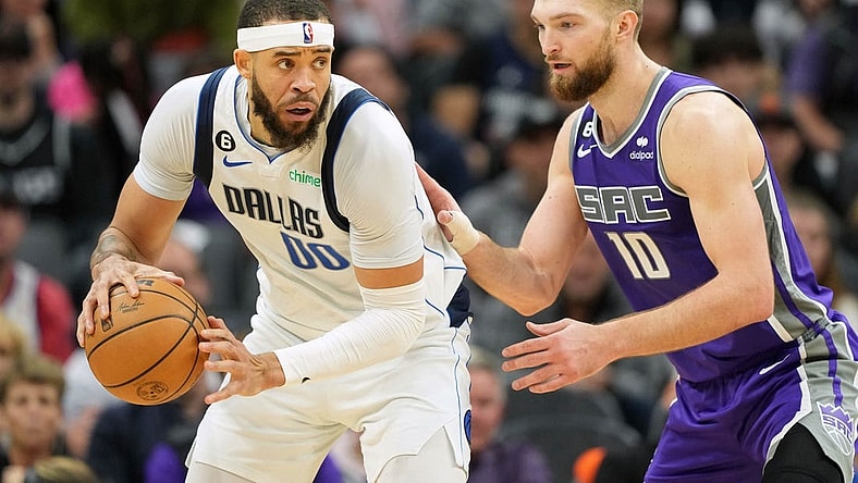 Feb 11, 2023; Sacramento, California, USA; Dallas Mavericks center JaVale McGee (00) handles the ball against Sacramento Kings forward Domantas Sabonis (10) during the third quarter at Golden 1 Center. Mandatory Credit: Darren Yamashita-USA TODAY Sports