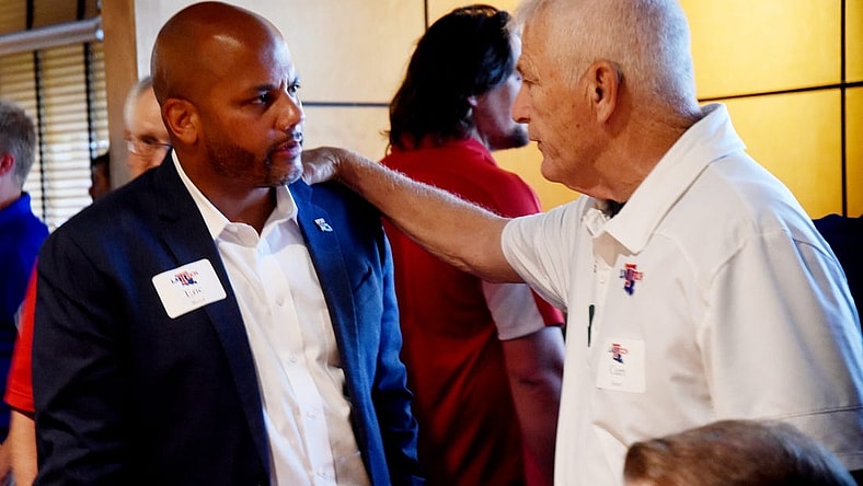 Louisiana Tech athletic director Eric Wood gets some advice from Curt Joiner during Tuesday's Bulldog Blitz at Shreveport's Cantina Laredo.