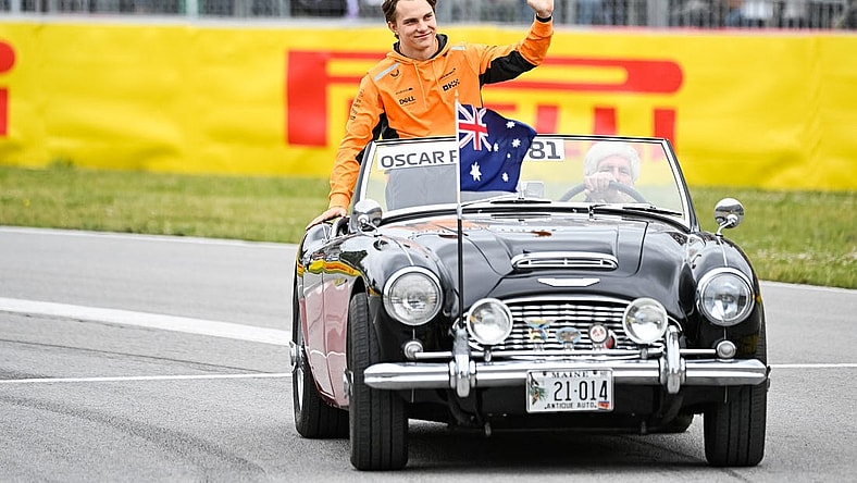 Jun 18, 2023; Montreal, Quebec, CAN; McLaren driver Oscar Piastri (AUS) parades and salutes the crowd before the Canadian Grand Prix at Circuit Gilles Villeneuve. Mandatory Credit: David Kirouac-USA TODAY Sports