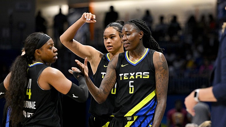 Jul 22, 2023; Arlington, Texas, USA; Dallas Wings guard Arike Ogunbowale (24) and forward Satou Sabally (0) and forward Natasha Howard (6) celebrate after they leave the game against the Los Angeles Sparks during the second half at College Park Center. Mandatory Credit: Jerome Miron-USA TODAY Sports