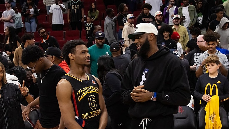 Mar 28, 2023; Houston, TX, USA; West guard Bronny James (6) with father LeBron James following the McDonald's All American Boy's high school basketball game at Toyota Center. Mandatory Credit: Mark J. Rebilas-USA TODAY Sports
