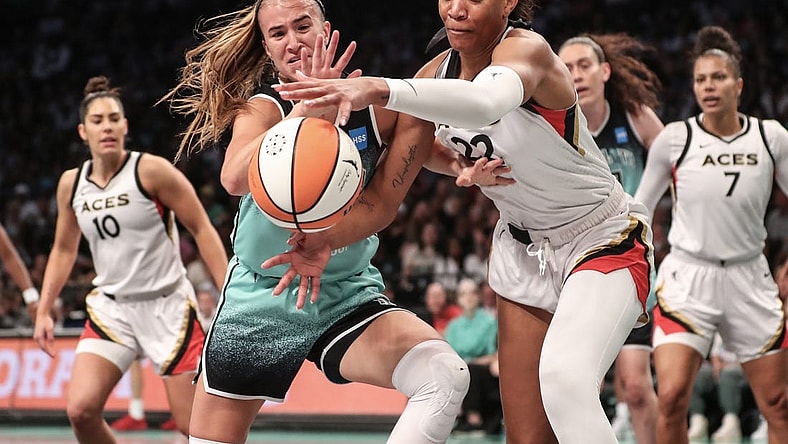 Aug 6, 2023; Brooklyn, New York, USA;  New York Liberty guard Sabrina Ionescu (20) and Las Vegas Aces forward A'ja Wilson (22) fight for a loose ball in the first quarter at Barclays Center. Mandatory Credit: Wendell Cruz-USA TODAY Sports