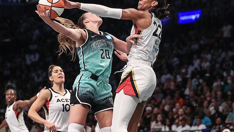 Aug 6, 2023; Brooklyn, New York, USA;  Las Vegas Aces forward A'ja Wilson (22) blocks a shot taken by New York Liberty guard Sabrina Ionescu (20) in the first quarter at Barclays Center. Mandatory Credit: Wendell Cruz-USA TODAY Sports
