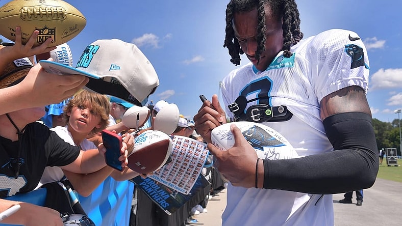 The Carolina Panthers and the New York Jets held a joint training camp practice at Wofford in Spartanburg on Aug. 9, 2023. Jaycee Horn (8) of the Carolina Panthers signs gear for fans.