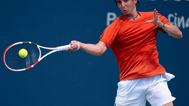 Alexander Shevchenko, of Russia, returns to M  rton Fucsovics, of Hungary, during the Western & Southern Open qualifying round in Cincinnati on Saturday, Aug. 12, 2023.