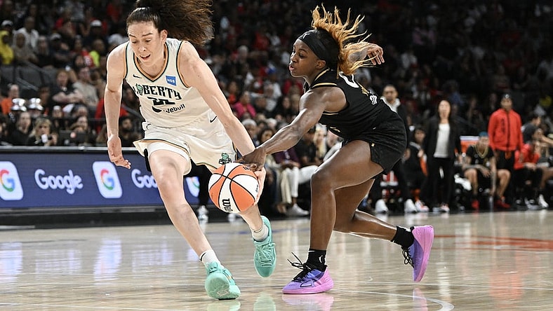 Aug 15, 2023; Las Vegas, Nevada, USA; New York Liberty forward Breanna Stewart (30) has the ball stripped by Las Vegas Aces guard Jackie Young (0) during the second quarter at Michelob Ultra Arena. Mandatory Credit: Candice Ward-USA TODAY Sports