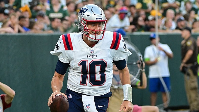 Aug 19, 2023; Green Bay, Wisconsin, USA; New England Patriots quarterback Mac Jones (10) reacts after the Patriots scored a touchdown against the Green Bay Packers at Lambeau Field. Mandatory Credit: Benny Sieu-USA TODAY Sports