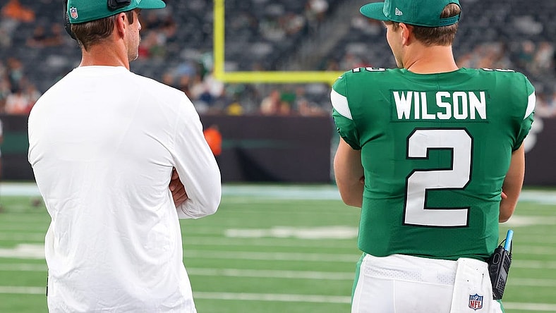 Aug 19, 2023; East Rutherford, New Jersey, USA; New York Jets quarterback Aaron Rodgers (8) and New York Jets quarterback Zach Wilson (2) talk during the second half of their game against the Tampa Bay Buccaneers at MetLife Stadium. Mandatory Credit: Ed Mulholland-USA TODAY Sports
