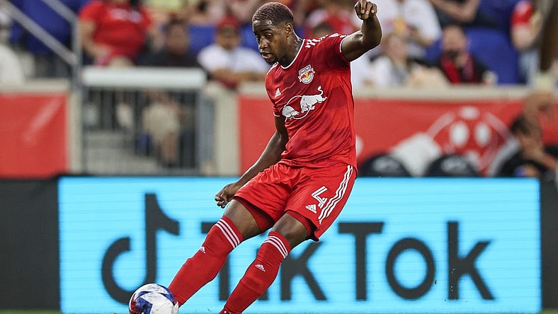 Aug 20, 2023; Harrison, New Jersey, USA; New York Red Bulls defender Andres Reyes (4) kicks the ball against D.C. United during the first half at Red Bull Arena. Mandatory Credit: Vincent Carchietta-USA TODAY Sports