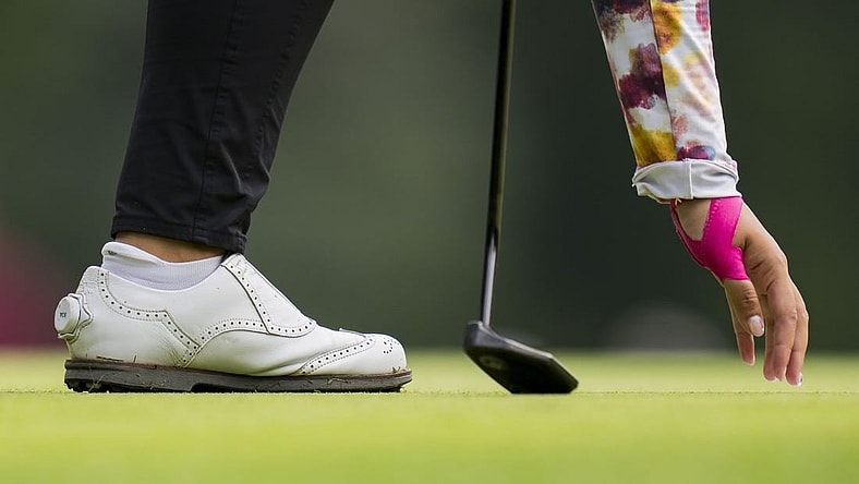 Aug 25, 2023; Vancouver, British Columbia, CAN; Lilia Vu picks her ball out of the hole on the sixth green during the second round of the CPKC Women's Open golf tournament at Shaughnessy Golf & Country Club. Mandatory Credit: Bob Frid-USA TODAY Sports