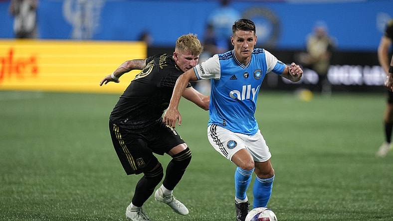 Aug 26, 2023; Charlotte, North Carolina, USA; Charlotte FC midfielder Ashley Westwood (8) plays the ball pressured by Los Angeles FC midfielder Mateusz Bogusz (19) in the second half in the second half at Bank of America Stadium. Mandatory Credit: Jim Dedmon-USA TODAY Sports