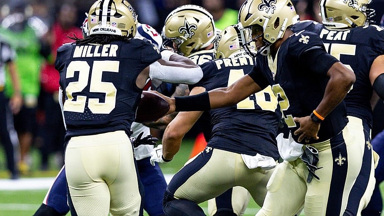 Aug 27, 2023; New Orleans, Louisiana, USA;  New Orleans Saints quarterback Jameis Winston (2) hands the ball off to running back Kendre Miller (25) against the Houston Texans during the first half at the Caesars Superdome. Mandatory Credit: Stephen Lew-USA TODAY Sports
