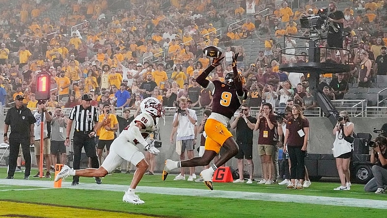Aug 31, 2023; Tempe, Arizona, USA; Arizona State Sun Devils wide receiver Troy Omeire (9) makes a touchdown catch over Southern Utah Thunderbirds cornerback Jehvonn Lewis (26) during a dust storm in the first half at Mountain America Stadium. Mandatory Credit: Rob Schumacher-Arizona Republic