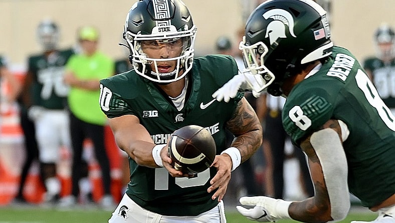 Sep 1, 2023; East Lansing, Michigan, USA;  Michigan State Spartans quarterback Noah Kim (10) hands the ball to Michigan State Spartans running back Jalen Berger (8) against the Central Michigan Chippewas at Spartan Stadium. Mandatory Credit: Dale Young-USA TODAY Sports