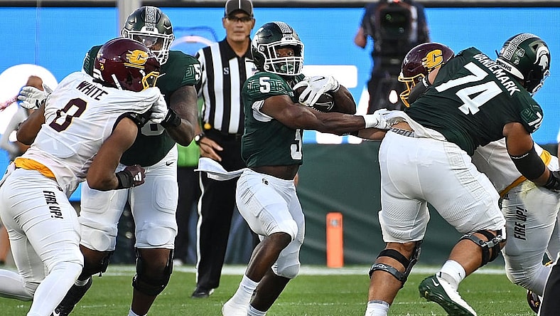 Sep 1, 2023; East Lansing, Michigan, USA;  Michigan State Spartans running back Nathan Carter (5) runs through a hole in the Central Michigan Chippewas line in the second quarter at Spartan Stadium. Mandatory Credit: Dale Young-USA TODAY Sports