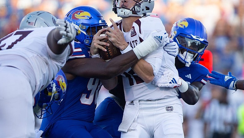 Kansas redshirt senior linebacker Tristian Fletcher (19) and junior defensive lineman Jereme Robinson (90) takes down Missouri State quarterback Jacob Clark (12) in the first quarter of Friday's game inside David Booth Kansas Memorial Stadium.