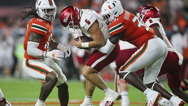 Sep 1, 2023; Miami Gardens, Florida, USA; Miami Hurricanes linebacker Wesley Bissainthe (31) sacks Miami Redhawks quarterback Brett Gabbert (5) during the second quarter at Hard Rock Stadium. Mandatory Credit: Sam Navarro-USA TODAY Sports