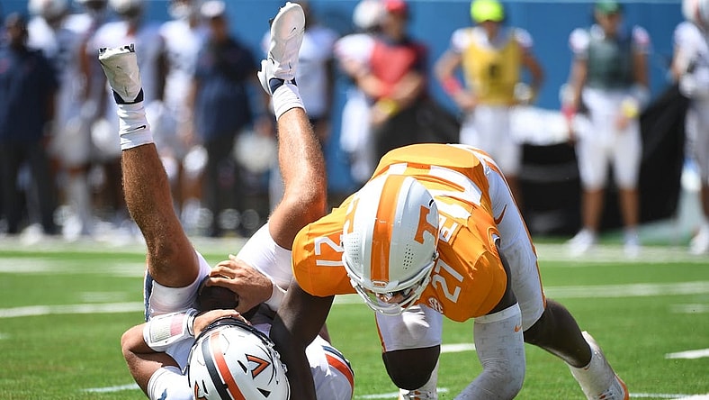 Sep 2, 2023; Nashville, Tennessee, USA; Virginia Cavaliers quarterback Tony Muskett (11) is sacked by Tennessee Volunteers defensive lineman James Pearce Jr. (27) during the first half at Nissan Stadium. Mandatory Credit: Christopher Hanewinckel-USA TODAY Sports
