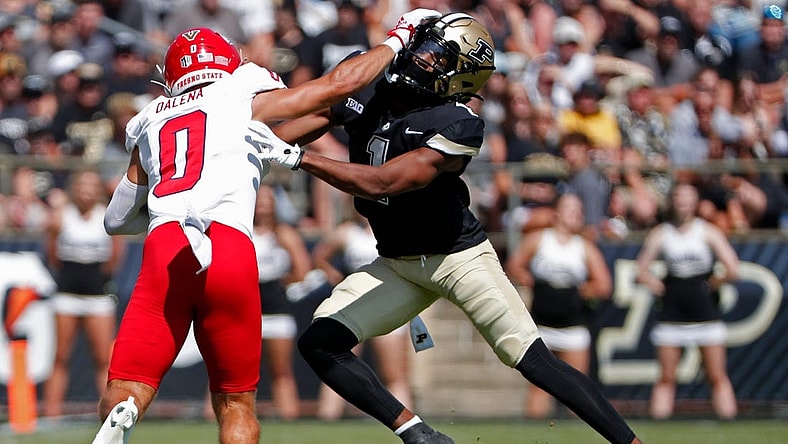Fresno State Bulldogs wide receiver Mac Dalena (0) stiff-arms Purdue Boilermakers defensive back Markevious Brown (1) during the NCAA football game, Saturday, Sept. 2, 2023, at Ross-Ade Stadium in West Lafayette, Ind.