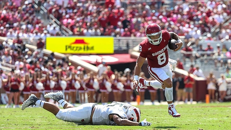 Sep 2, 2023; Norman, Oklahoma, USA; Oklahoma Sooners quarterback Dillon Gabriel (8) runs past Arkansas State Red Wolves defensive lineman Micah Bland (55) during the second quarter at Gaylord Family-Oklahoma Memorial Stadium. Mandatory Credit: Kevin Jairaj-USA TODAY Sports