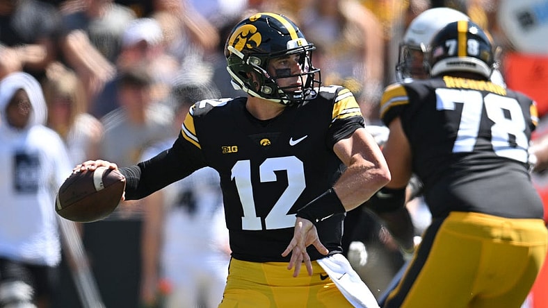 Sep 2, 2023; Iowa City, Iowa, USA; Iowa Hawkeyes quarterback Cade McNamara (12) throws a pass against the Utah State Aggies during the second quarter at Kinnick Stadium. Mandatory Credit: Jeffrey Becker-USA TODAY Sports