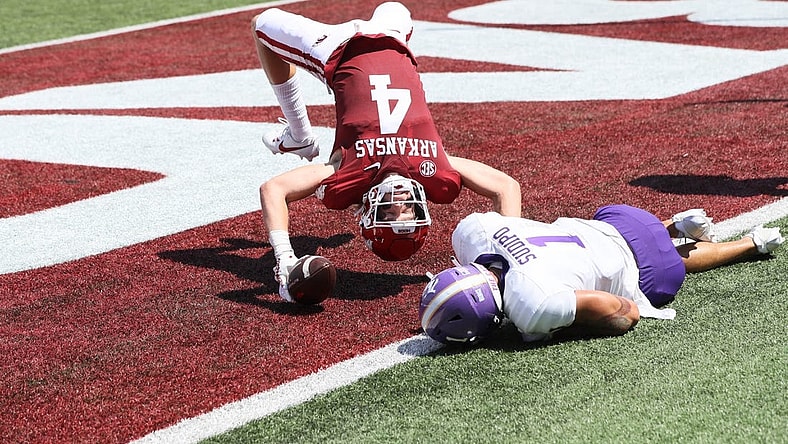 Sep 2, 2023; Little Rock, Arkansas, USA; Arkansas Razorbacks wide receiver Isaac TeSlaa (4) scores a touchdown in the first quarter as Western Carolina Catamounts safety Mateo Sudipo (1) defends at War Memorial Stadium. Mandatory Credit: Nelson Chenault-USA TODAY Sports