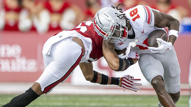 Sep 2, 2023; Bloomington, Indiana, USA; Ohio State Buckeyes wide receiver Marvin Harrison Jr. (18) is tackled by Indiana Hoosiers defensive back Nic Toomer (15) during the first quarter at Memorial Stadium. Mandatory Credit: Marc Lebryk-USA TODAY Sports