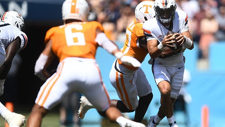 Virginia Cavaliers quarterback Tony Muskett (11) is met by Volunteers defensive lineman James Pearce Jr. (27) during their game at Nissan Stadium Saturday, Sept. 2, 2023.