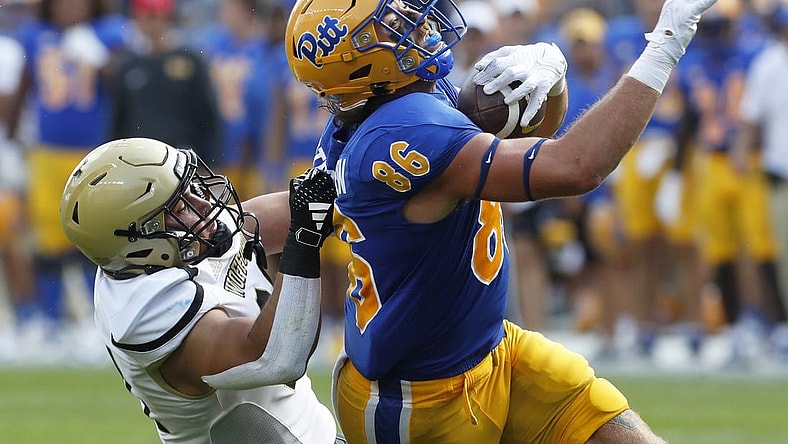 Sep 2, 2023; Pittsburgh, Pennsylvania, USA;  Pittsburgh Panthers tight end Gavin Bartholomew (86) makes a catch as Wofford Terriers linebacker David Powers (34) during the second quarter at Acrisure Stadium. Mandatory Credit: Charles LeClaire-USA TODAY Sports