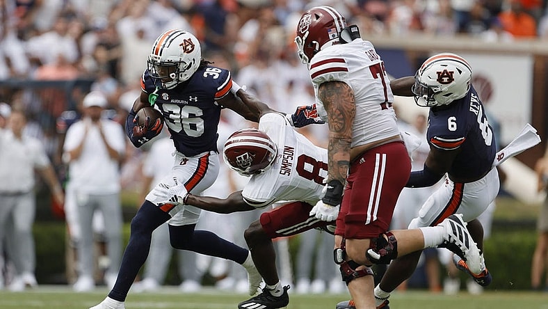 Sep 2, 2023; Auburn, Alabama, USA;  Massachusetts Minutemen wide receiver Anthony Simpson (8) moves in to tackle Auburn Tigers cornerback Jaylin Simpson (36) after Simpson recovered a fumble during the second quarter at Jordan-Hare Stadium. Mandatory Credit: John Reed-USA TODAY Sports