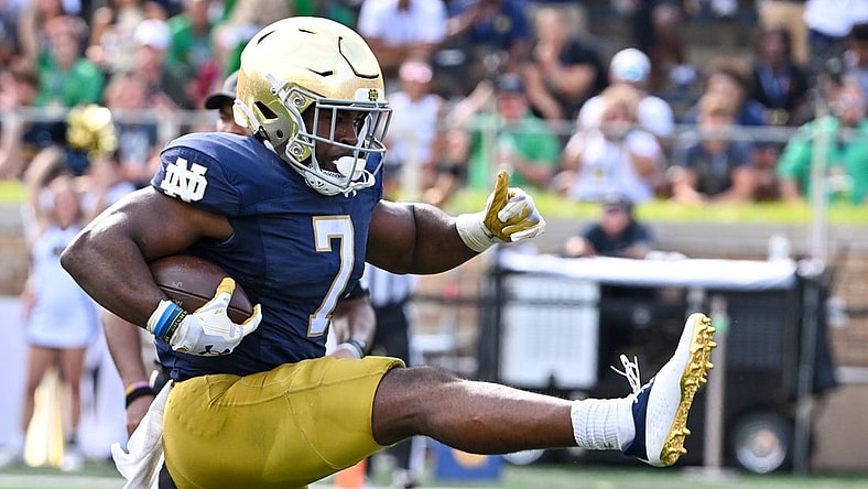 Sep 2, 2023; South Bend, Indiana, USA; Notre Dame Fighting Irish running back Audric Estime (7) scores in the second quarter against the Tennessee State Tigers at Notre Dame Stadium. Mandatory Credit: Matt Cashore-USA TODAY Sports
