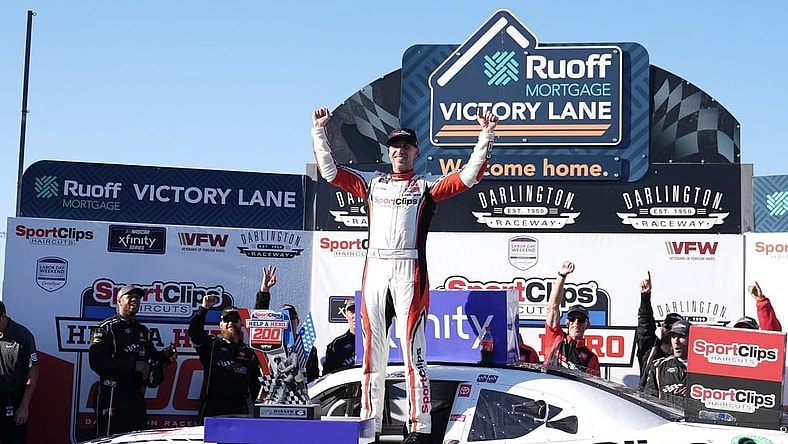 Sep 2, 2023; Darlington, South Carolina, USA; NASCAR Xfinity Series driver Denny Hamlin (19) celebrates in Victory Lane after winning the NASCAR Xfinity Series Sport Clips Haircuts VFW Help A Hero 200 at Darlington Raceway. Mandatory Credit: David Yeazell-USA TODAY Sports