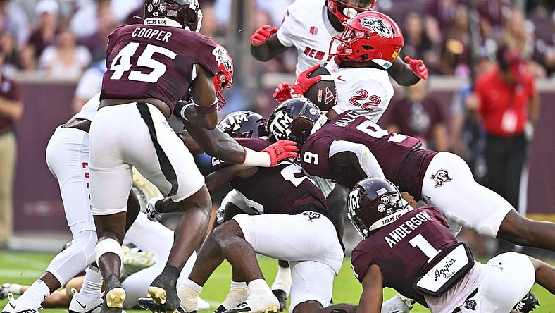 Sep 2, 2023; College Station, Texas, USA; New Mexico Lobos running back Christian Washington (22) is tackled during the second quarter against the Texas A&M Aggies at Kyle Field. Mandatory Credit: Maria Lysaker-USA TODAY Sports