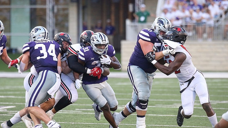 Sep 2, 2023; Manhattan, Kansas, USA; Kansas State Wildcats running back DJ Giddens (31) is tacked by Southeast Missouri State Redhawks defensive lineman LaWilliam Holmes (91) and linebacker Jacob Morrissey (44) during the second quarter at Bill Snyder Family Football Stadium. Mandatory Credit: Scott Sewell-USA TODAY Sports